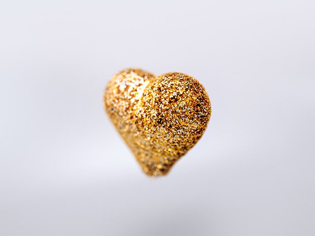 Heart made of gold INGUN test probes on a grey background